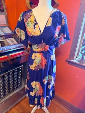 Trashy Diva Violet dress is showgirl feathers print. Size 18